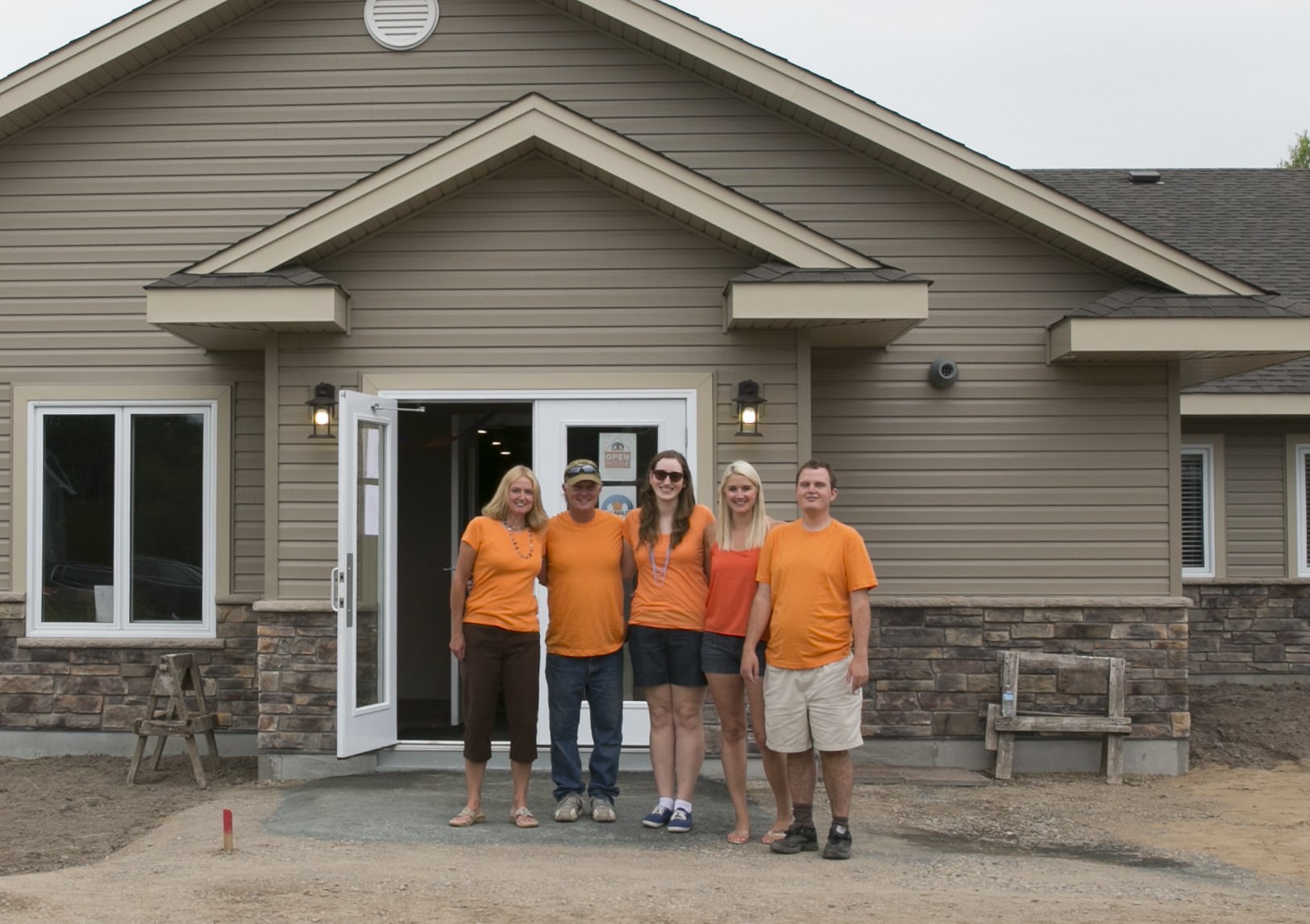 The team standing in front of the new home.